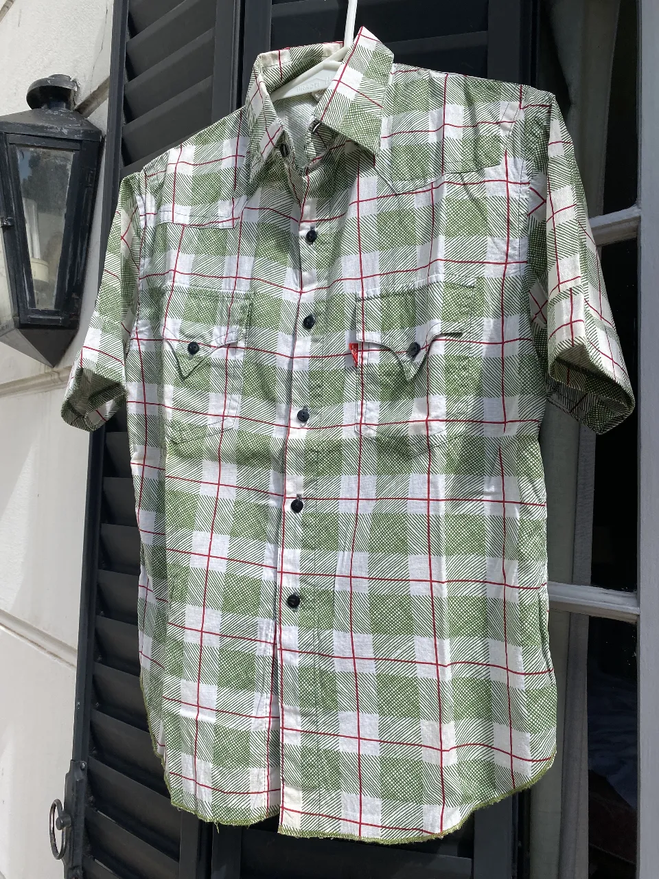 Camisa a cuadros verde y blanca con detalles en rojo. Ideal para un look casual y relajado. Perfecta para usar en cualquier ocasión.