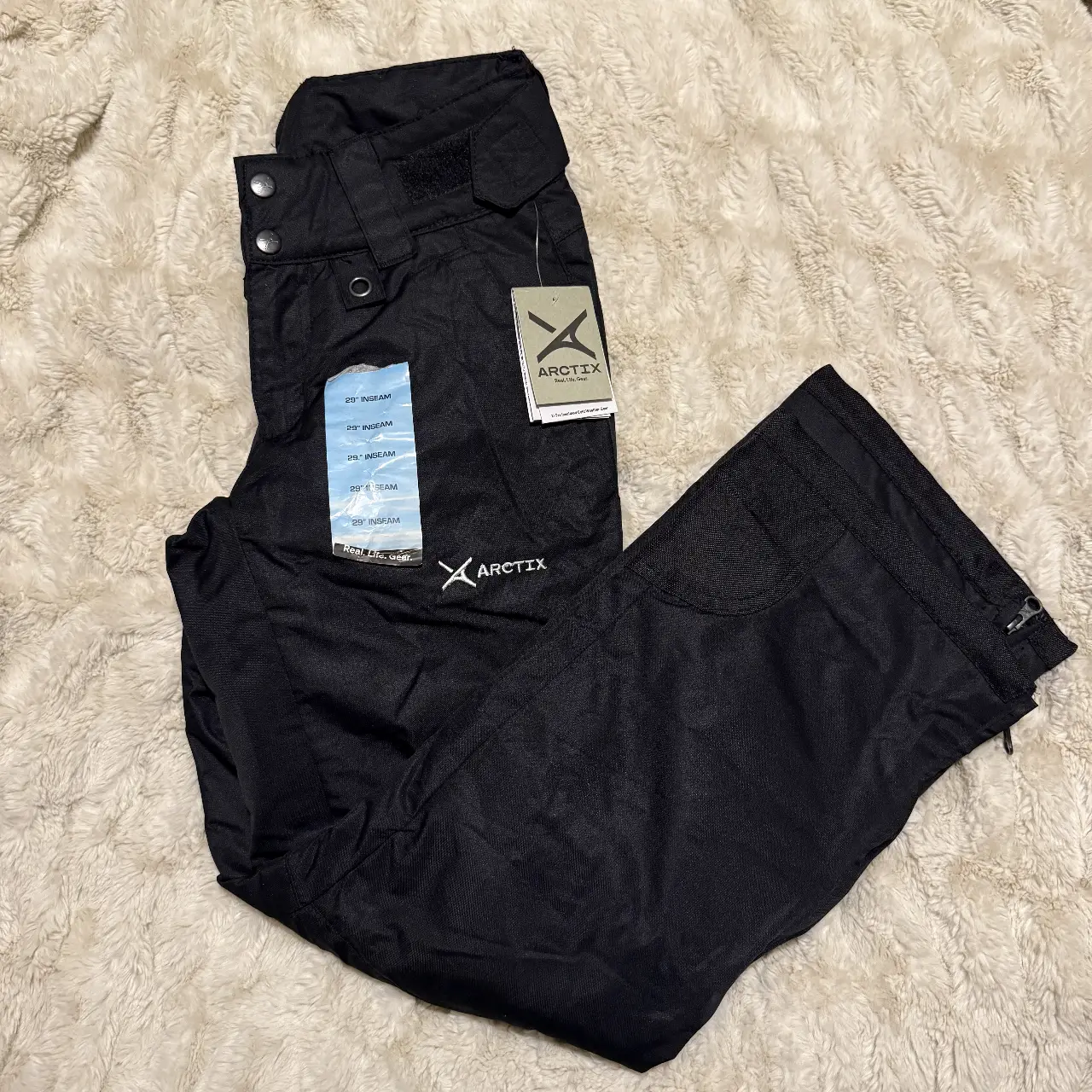 Pantalón de esquí Arctix para mujer XS, color negro, con múltiples etiquetas de talle 29" de largo de entrepierna. Ideal para actividades en la nieve.