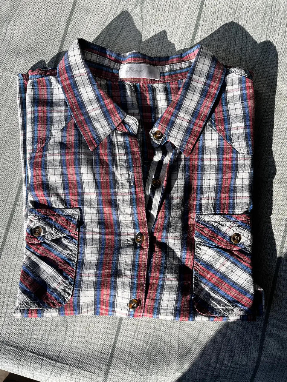 Camisa a cuadros de mujer, de manga larga, con bolsillos en el pecho. Ideal para un look casual y cómodo.