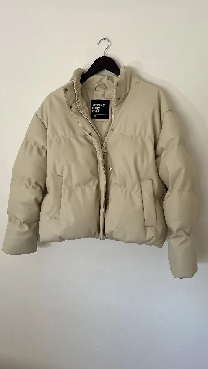 Campera puffer de mujer, color crudo, con cierre y bolsillos. Ideal para el invierno, abrigo y estilo en una sola prenda. Talle L pero va para un M también 