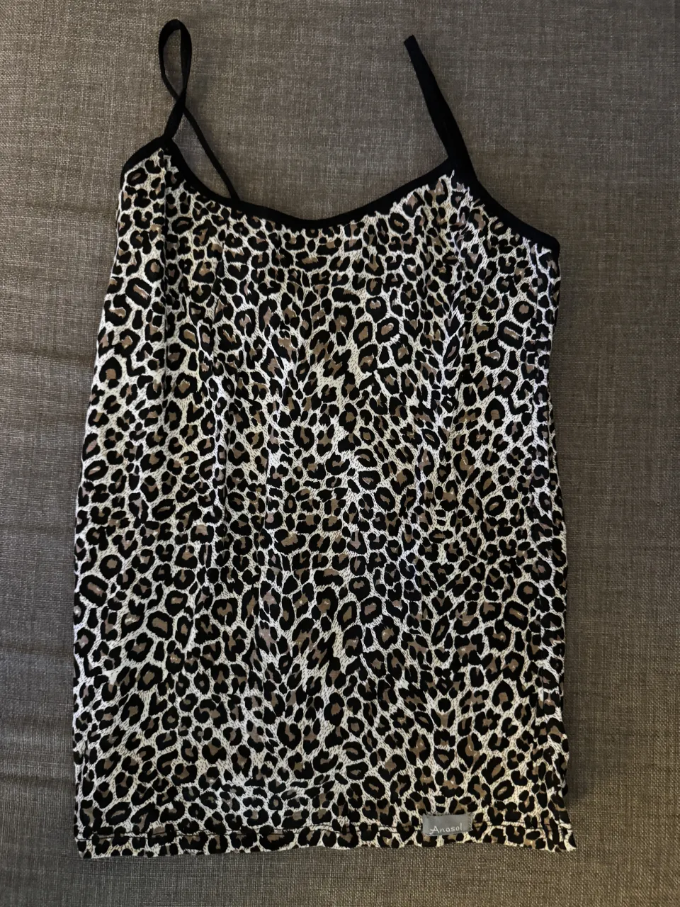 Remera de tiras con estampa animal print de leopardo con pollera negra con bolados. Ideal para un look canchero y moderno.