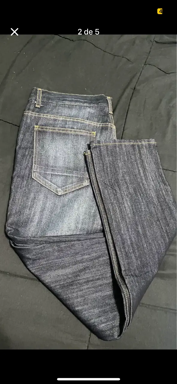 Jeans de hombre, corte recto, color azul oscuro. Con etiqueta de talle y marca.