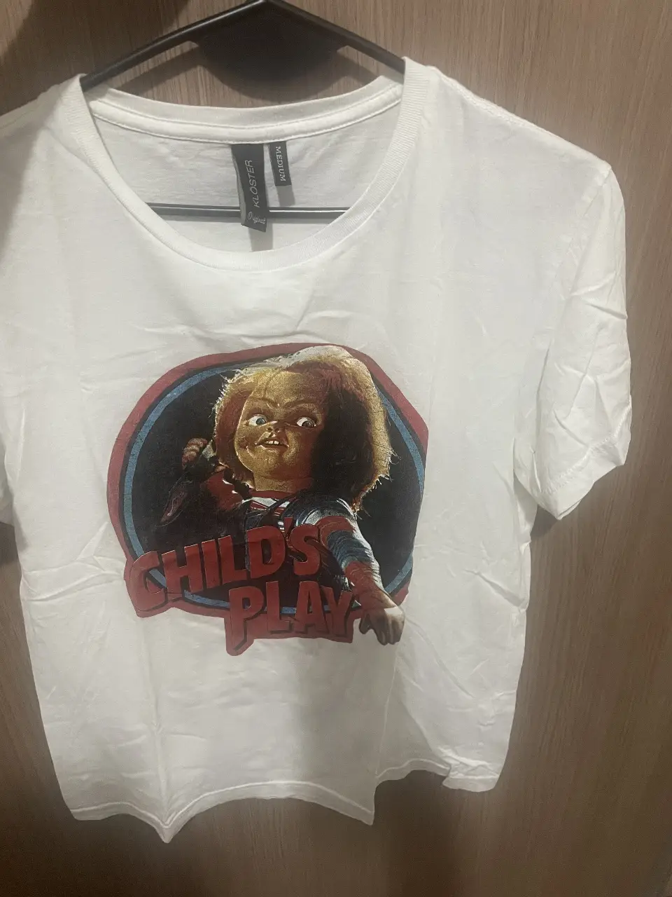 Remera blanca de algodón con estampado de Chucky, el muñeco diabólico, ideal para un look casual y con onda.