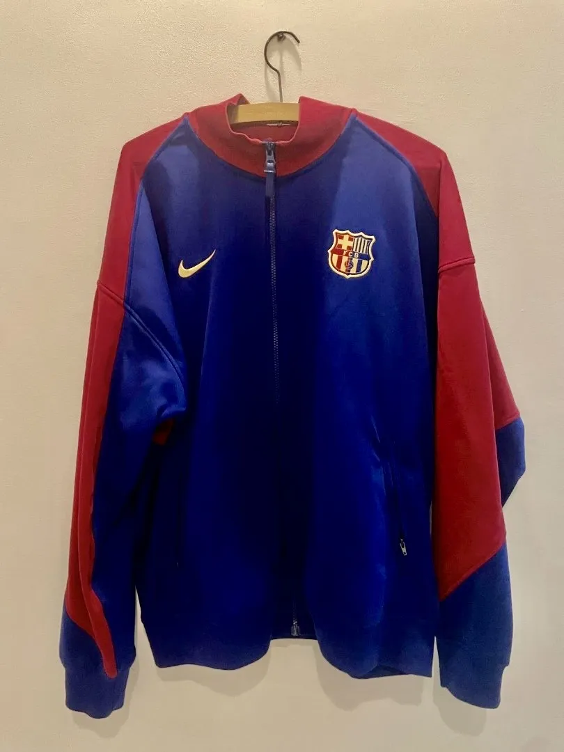 Campera deportiva Nike del FC Barcelona, ideal para los fanáticos del fútbol. Diseño moderno y cómodo, perfecta para usar en el día a día o para entrenar.