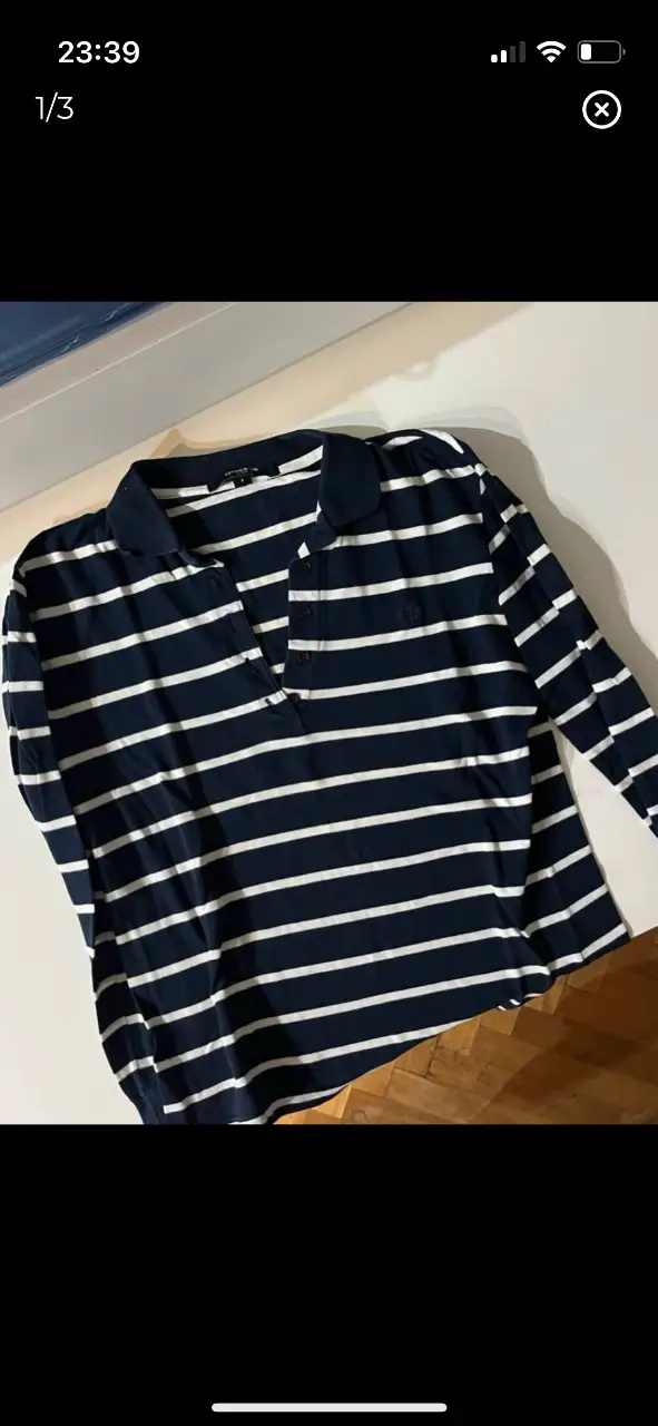 Remera manga larga de mujer a rayas horizontales en azul marino y blanco. Cuello polo con botones y logo bordado. Ideal para un look casual y cómodo. tela pique