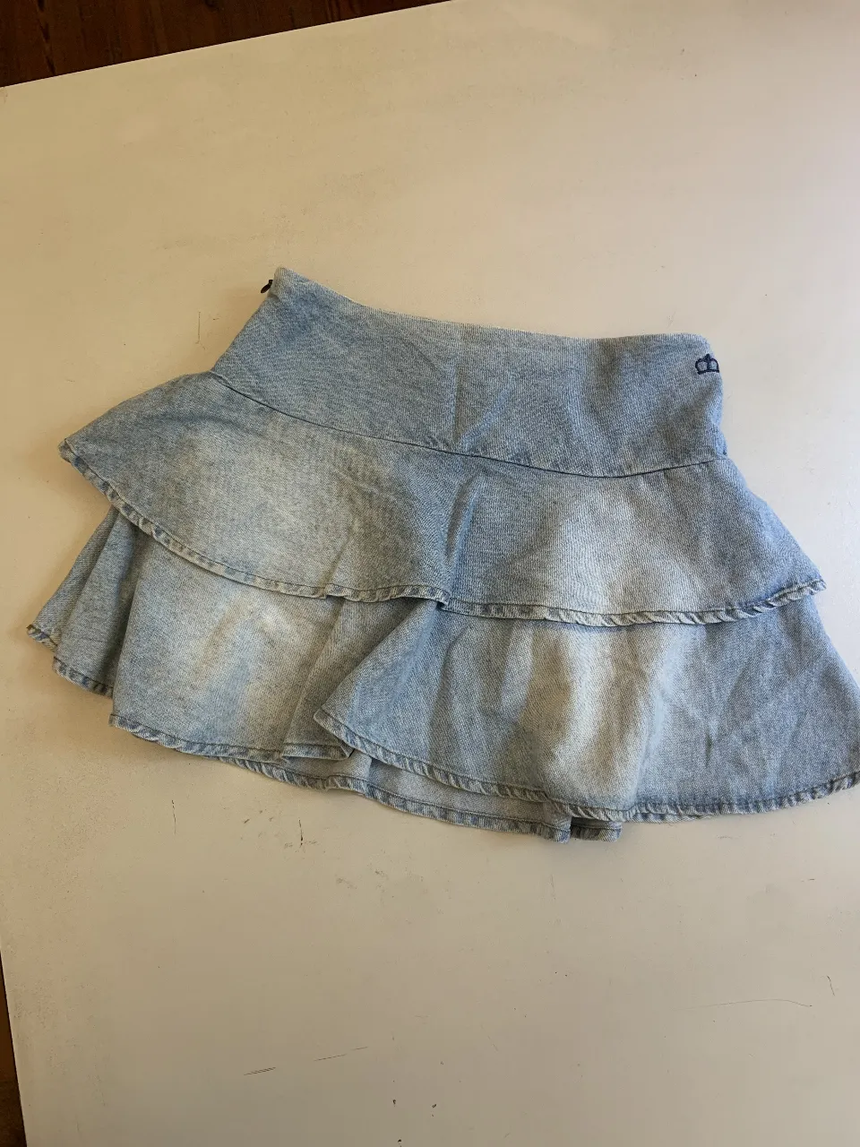 Pollera de jean con volados y forro a cuadros en la cintura. Talle 8. Ideal para un look casual y canchero.