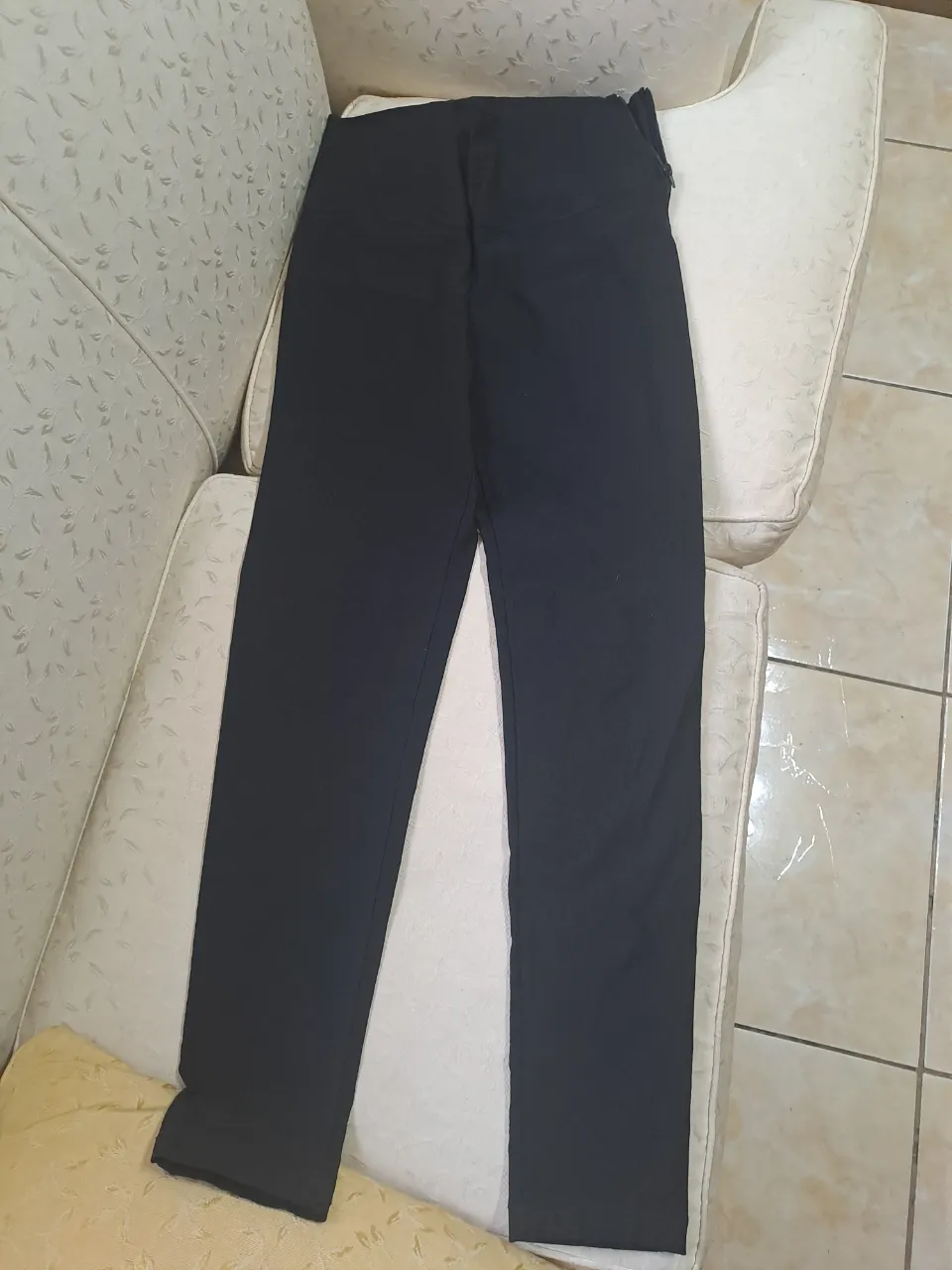 Pantalón negro tiro alto con cierre lateral, tipo chupin. Ideal para un look elegante o casual. Tela elastizada. Sin uso.