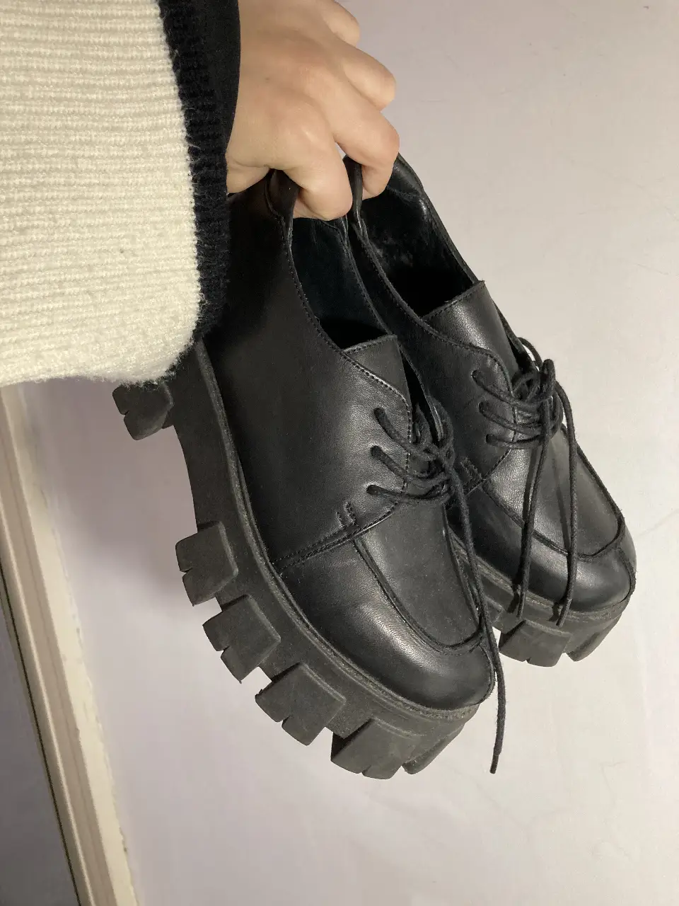 Borcegos negros con suela gruesa y cordones. Ideales para un look urbano y moderno.