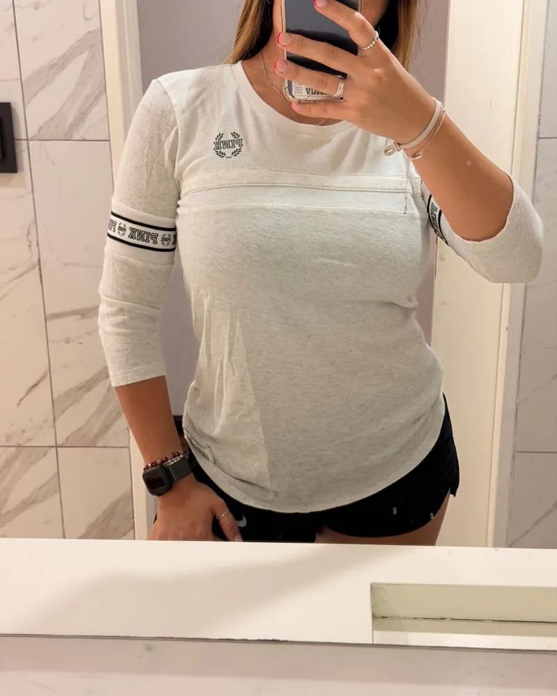 Remera manga 3/4 de algodón, color gris claro, con detalles de la marca en las mangas y en el pecho. Ideal para un look casual y cómodo.