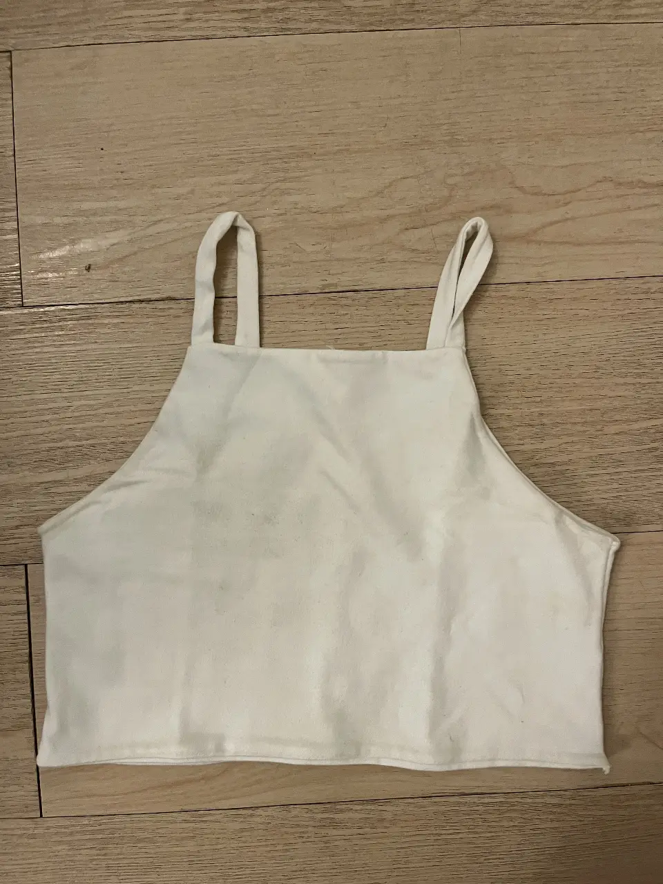 Top blanco de mujer, con breteles finos y diseño simple. Básico infaltable en tu armario. Ideal para combinar con diferentes outfits casuales.