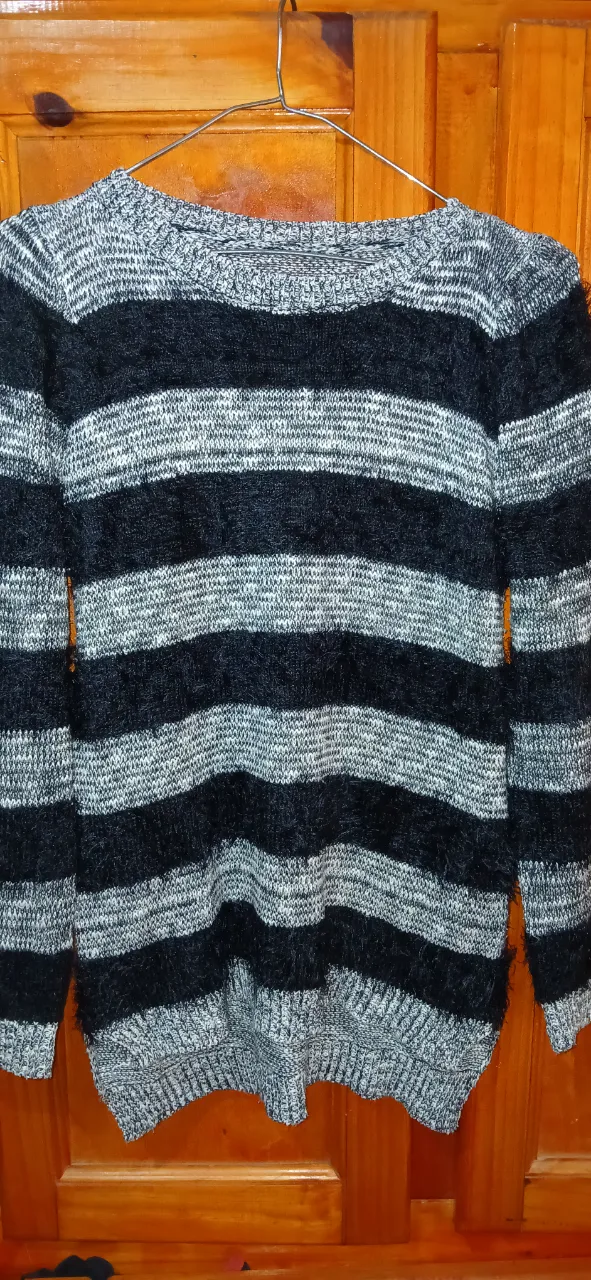 Sweater a rayas horizontales en gris y negro, ideal para un look casual y abrigado. Perfecto para el invierno.