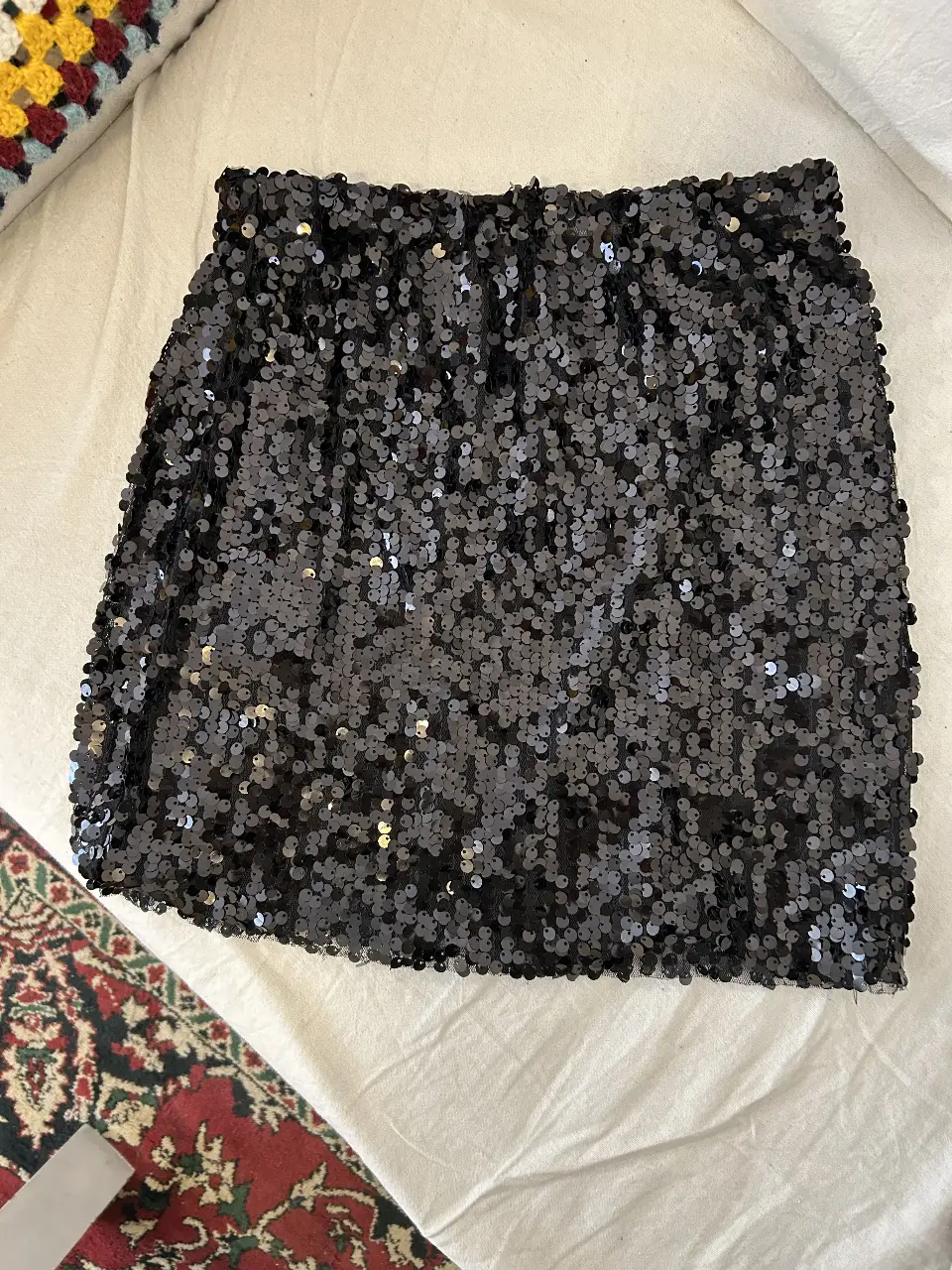 Pollera midi con lentejuelas negras, ideal para fiestas y eventos especiales. Un básico de fiesta que no puede faltar en tu guardarropa.