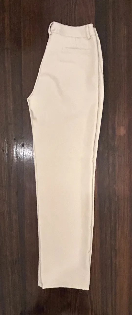 Pantalón sastrero color crudo, de corte recto y tiro alto. Ideal para un look elegante y versátil.
