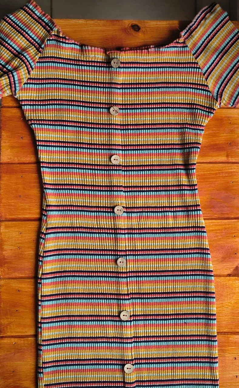 Vestido de mangas cortas, con cuello redondo y botones al frente. Diseño a rayas multicolor. Talle L, también va en talle M o XL porque se ajusta al cuerpo. 

