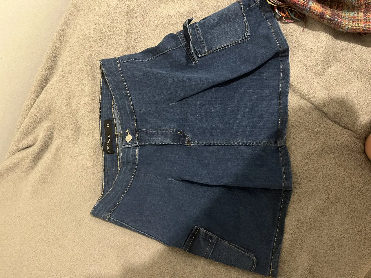 Pollera de jean azul con bolsillos cargo. Talle 48. Ideal para un look casual y cómodo.