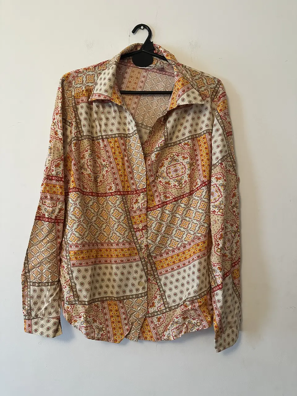 Camisa estampada de manga larga con diseño patchwork en tonos beige, amarillo y rojo. Ideal para un look casual con un toque vintage.
