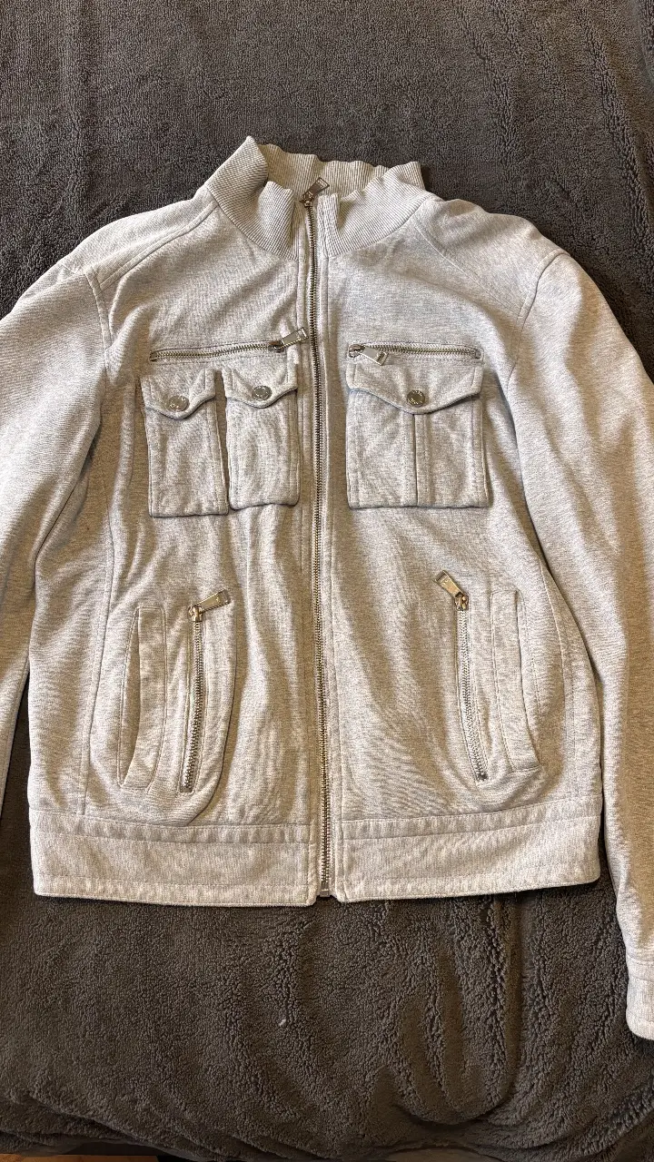 Buzo de hombre Zara Man, color gris, con cierre y bolsillos. Talle M. Ideal para un look casual y canchero.