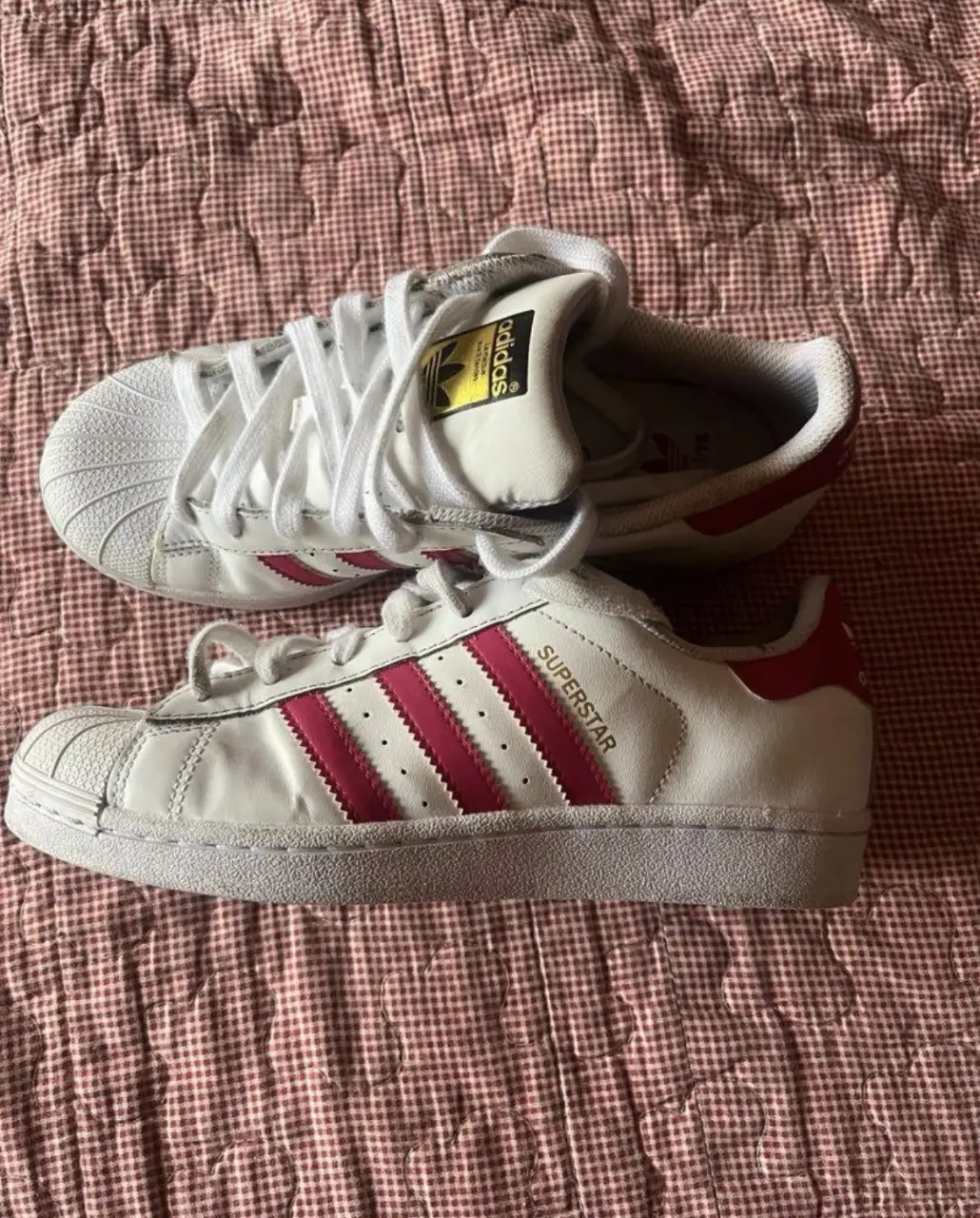 Zapatillas Adidas Superstar blancas con detalles en rosa. Talle 36. Ideales para un look casual y deportivo.