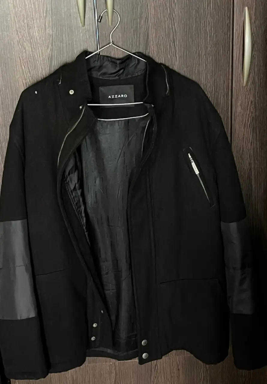 Campera negra de hombre, con detalles en cuero sintético en los hombros y mangas. Cierre frontal y bolsillos con cierre. Marca Azzaro.