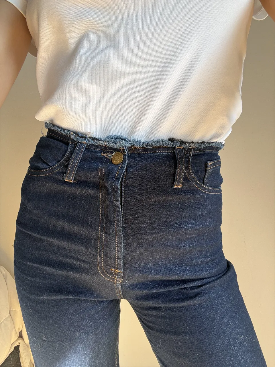 Jean de moldería recta, tiro alto, con detalles desflecados en la cintura y en los botamangas. Un clásico que no puede faltar en tu guardarropas.