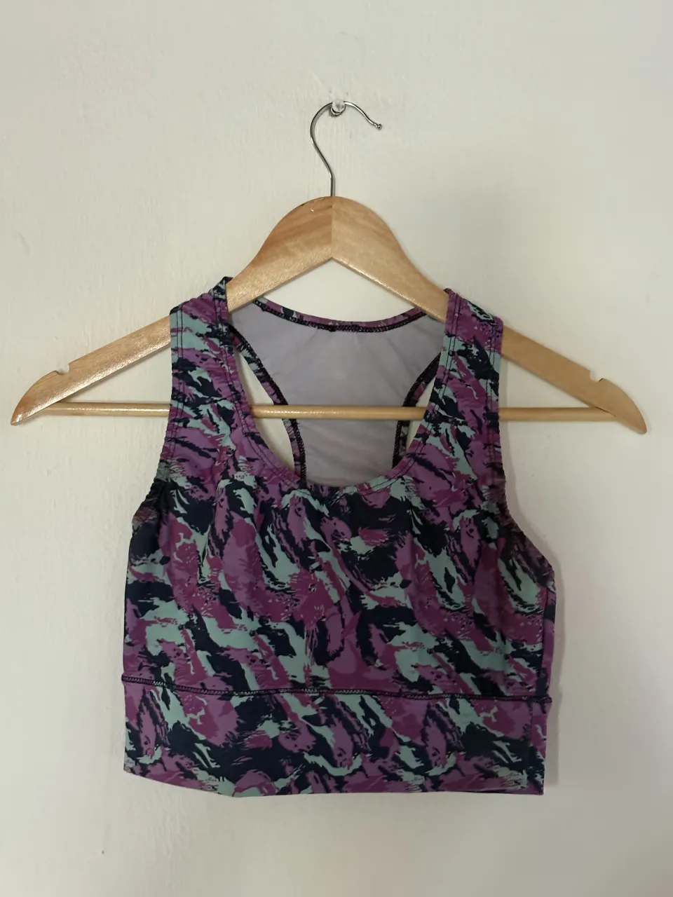 Top deportivo estampado en tonos de violeta, azul y verde. Ideal para entrenar o para un look casual y cómodo.