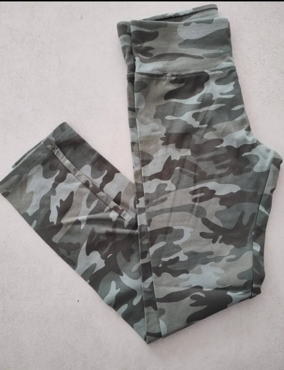 Calzas de mujer con estampado camuflado en tonos verdes y grises. Ideal para actividades deportivas o uso casual.
