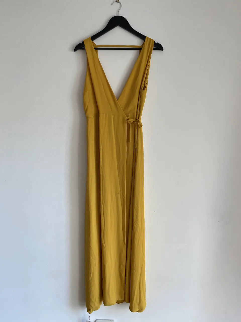 Vestido largo de color amarillo mostaza, con escote en V y corte envolvente. Ideal para eventos formales o salidas especiales.
