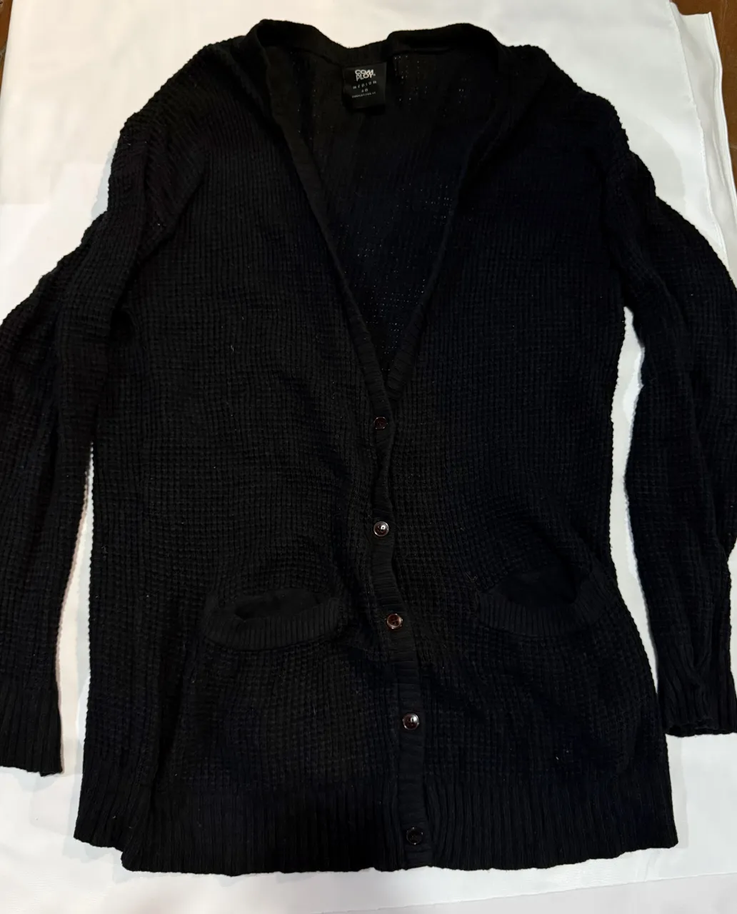 Cardigan negro de tejido waffle maxi sweater , con botones al frente y bolsillos. Ideal para un look casual y cómodo. llega a las rodillas 