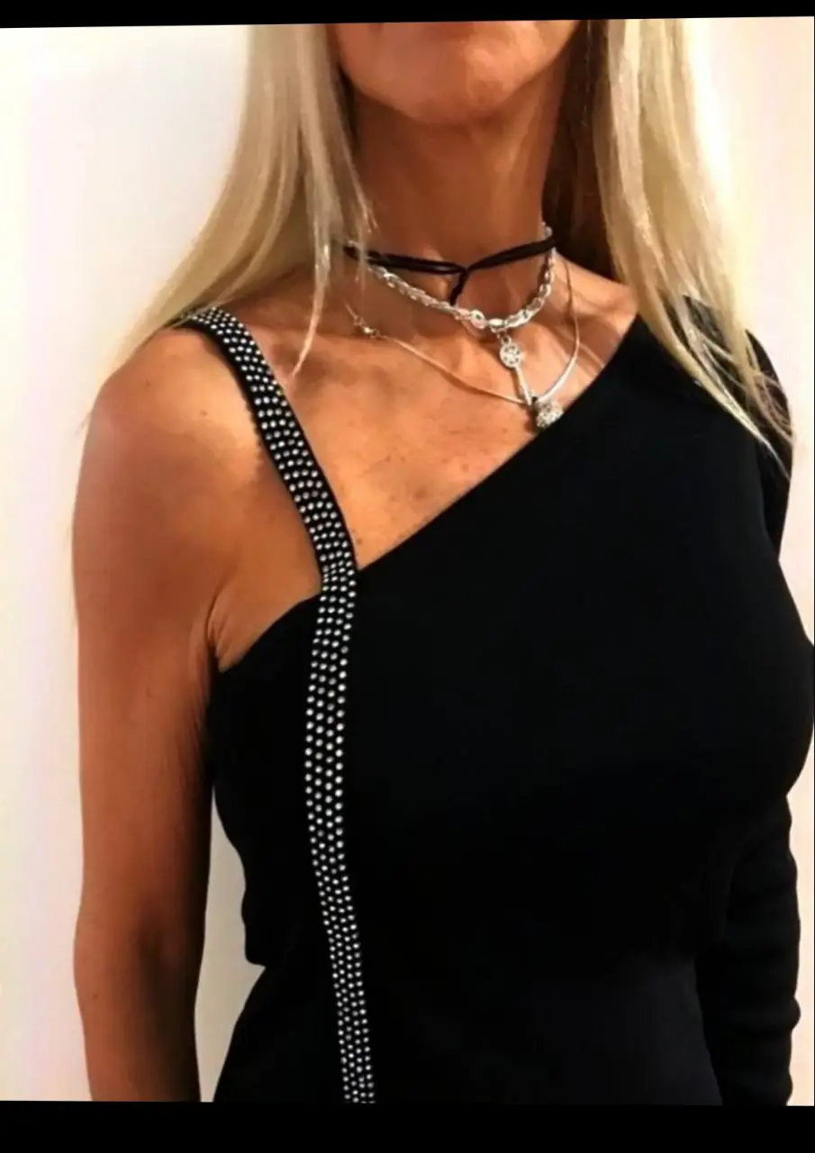 Remera  ,Sueter negro asimétrico con un solo hombro y detalle de brillos en la tira. Ideal para fiestas y eventos. hilo y Spandex S/ M. una manga y bretel de strass ,Nuevo