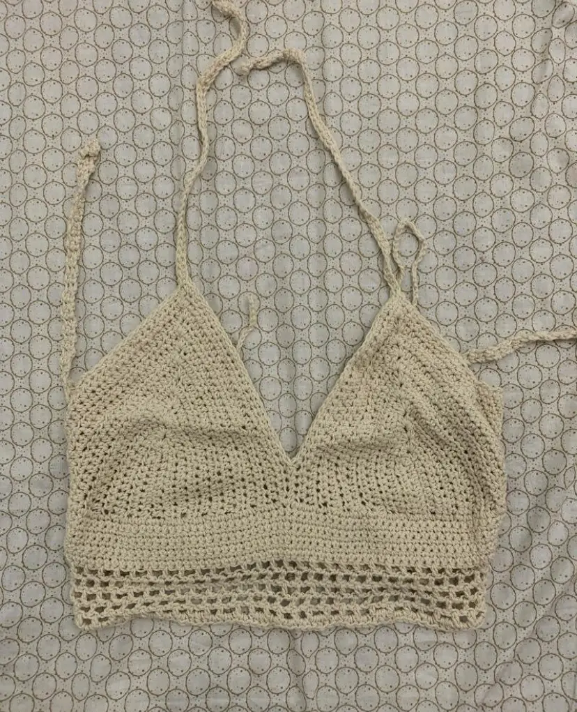 Top tejido a crochet en color crudo, con diferentes tiras para atar y regular