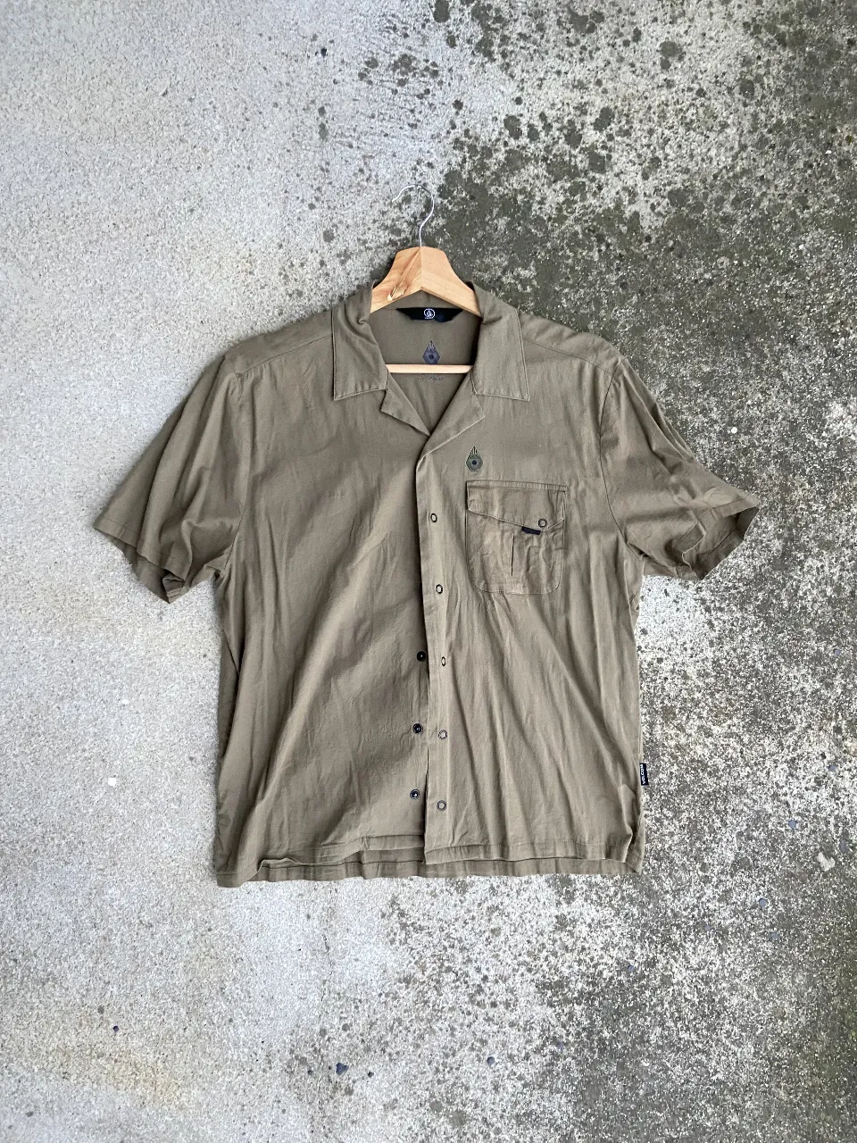 Camisa de hombre manga corta color verde oscuro, con botones y bolsillo en el pecho. Ideal para un look casual y cómodo.