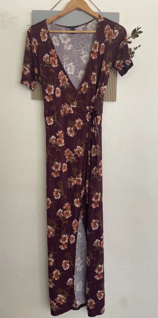 Vestido largo estampado floral, con escote cruzado y tajos. Ideal para un look casual y fresco.