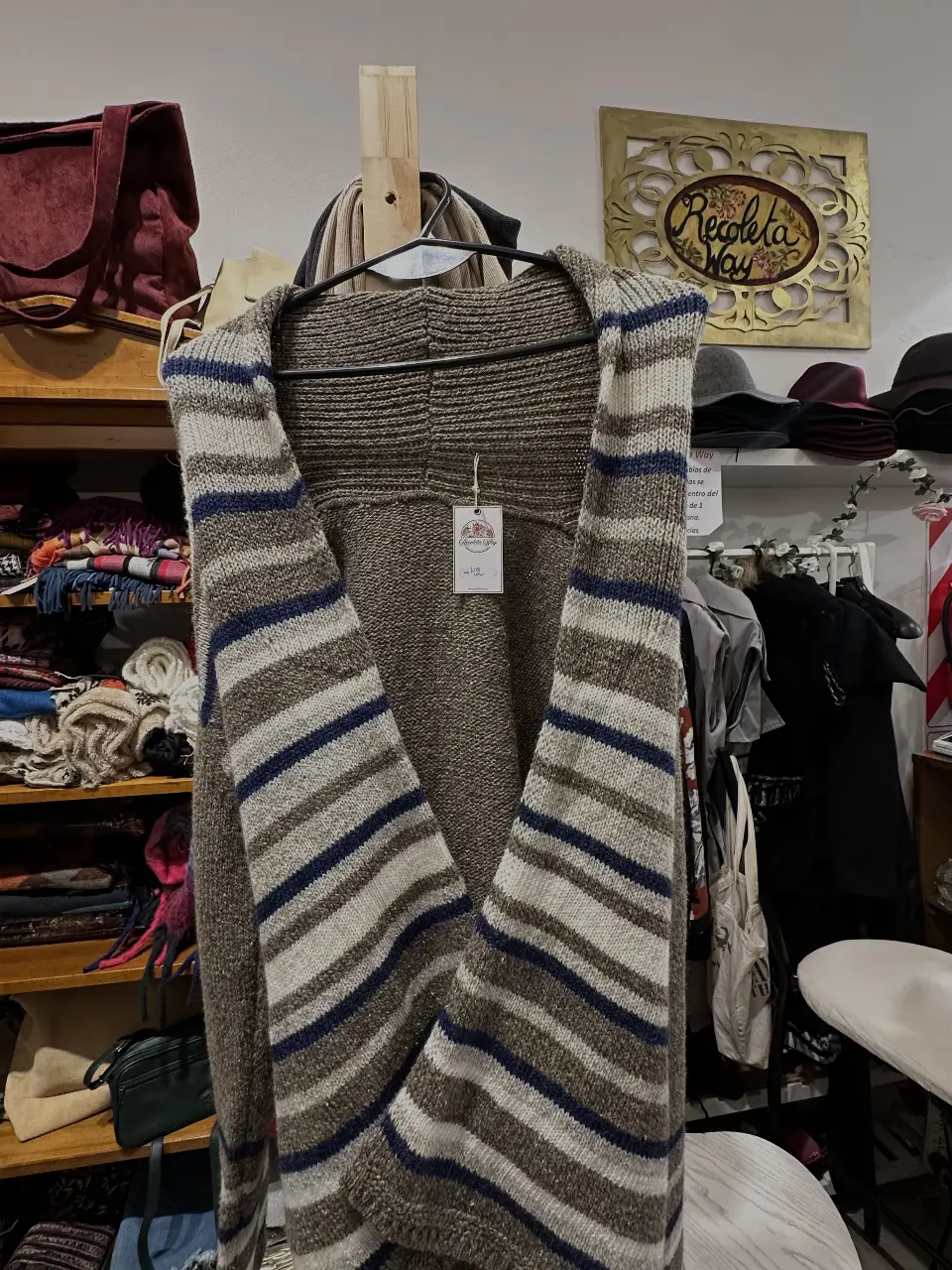 Cardigan tejido a rayas en tonos marrones y blanco. Ideal para un look casual y abrigado.