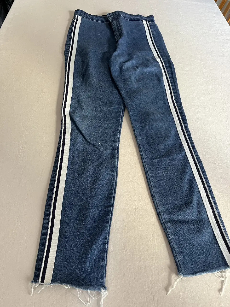 Jeans de mujer rectos, tiro medio, con detalle de franjas blancas laterales. Un clásico renovado para un look casual y canchero.