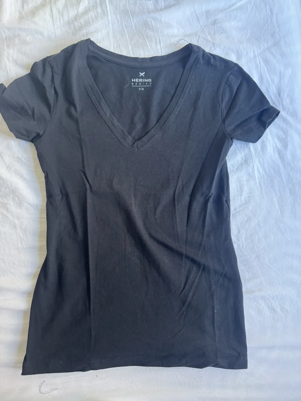 Remera negra de manga corta con cuello en V.
medidas
Largo 58
Ancho 36