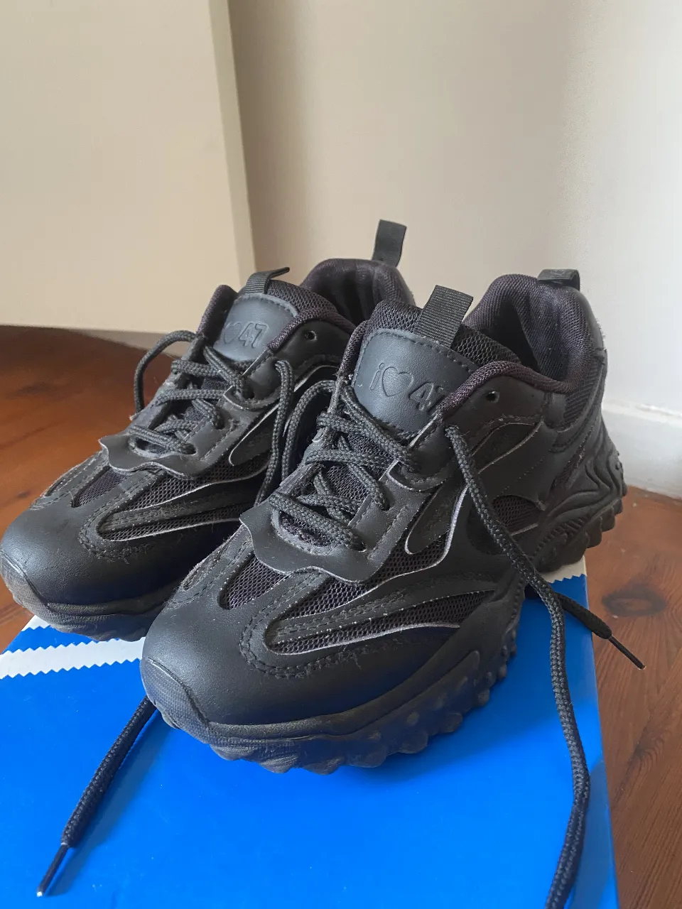 Zapatillas negras deportivas con detalles en blanco. Ideales para un look urbano y cómodo. Perfectas para el día a día.