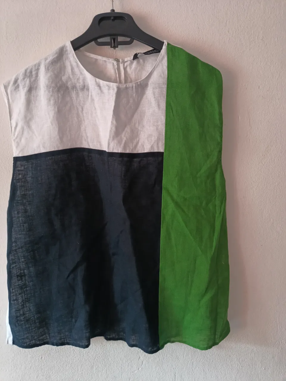 Musculosa de lino con bloques de color blanco, negro y verde. Espalda con abertura y botón.