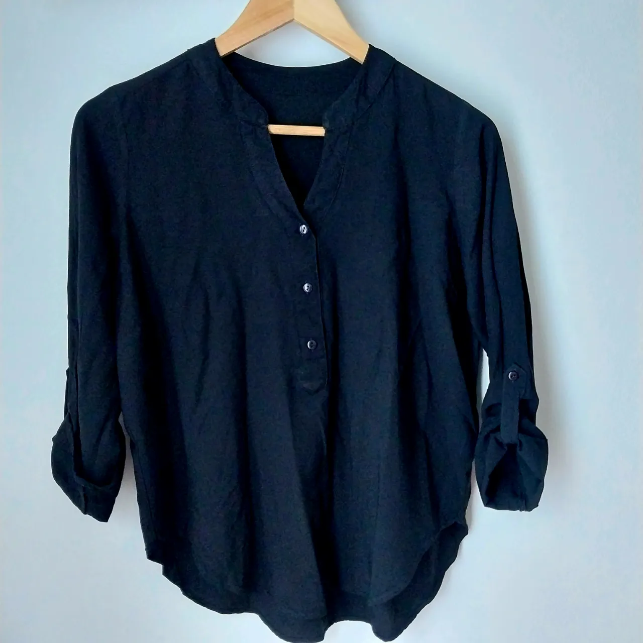 Remera le utthe negra de manga 3/4 con cuello mao y botones al frente. Ideal para un look casual y cómodo.