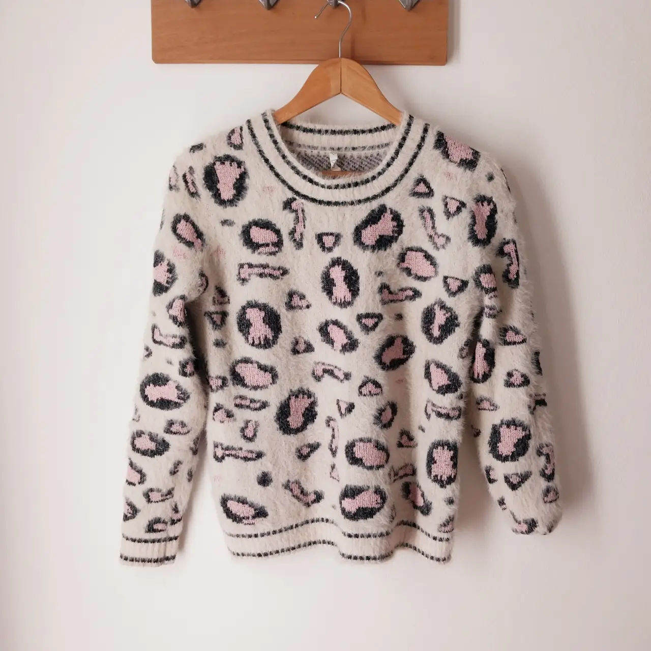 Sweater de mujer con estampado de leopardo en tonos blanco y rosa. Ideal para un look casual y moderno.