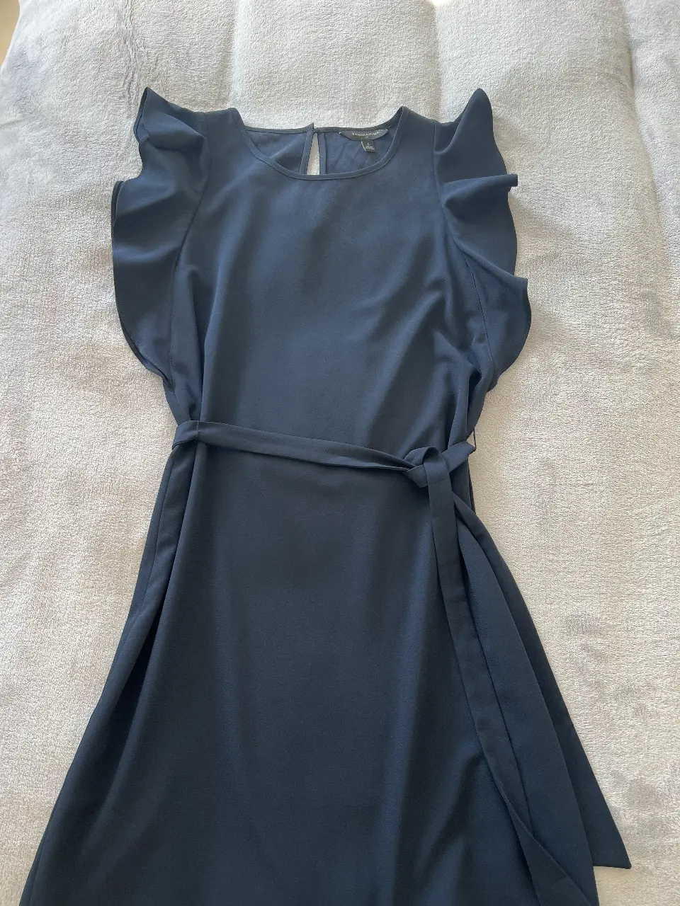 Vestido midi azul marino de Banana Republic, con mangas cortas con volados y cinturón para ajustar la cintura. Ideal para un look elegante y fresco.