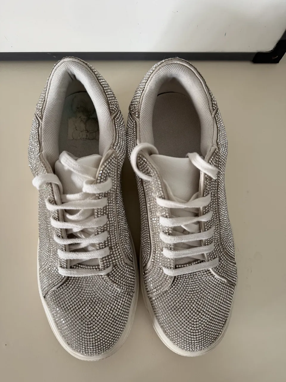 Zapatillas urbanas súper brillosas, ideales para darle un toque glamoroso a cualquier look. Perfectas para destacar en salidas nocturnas o eventos especiales. Su diseño con strass las hace únicas y llamativas.