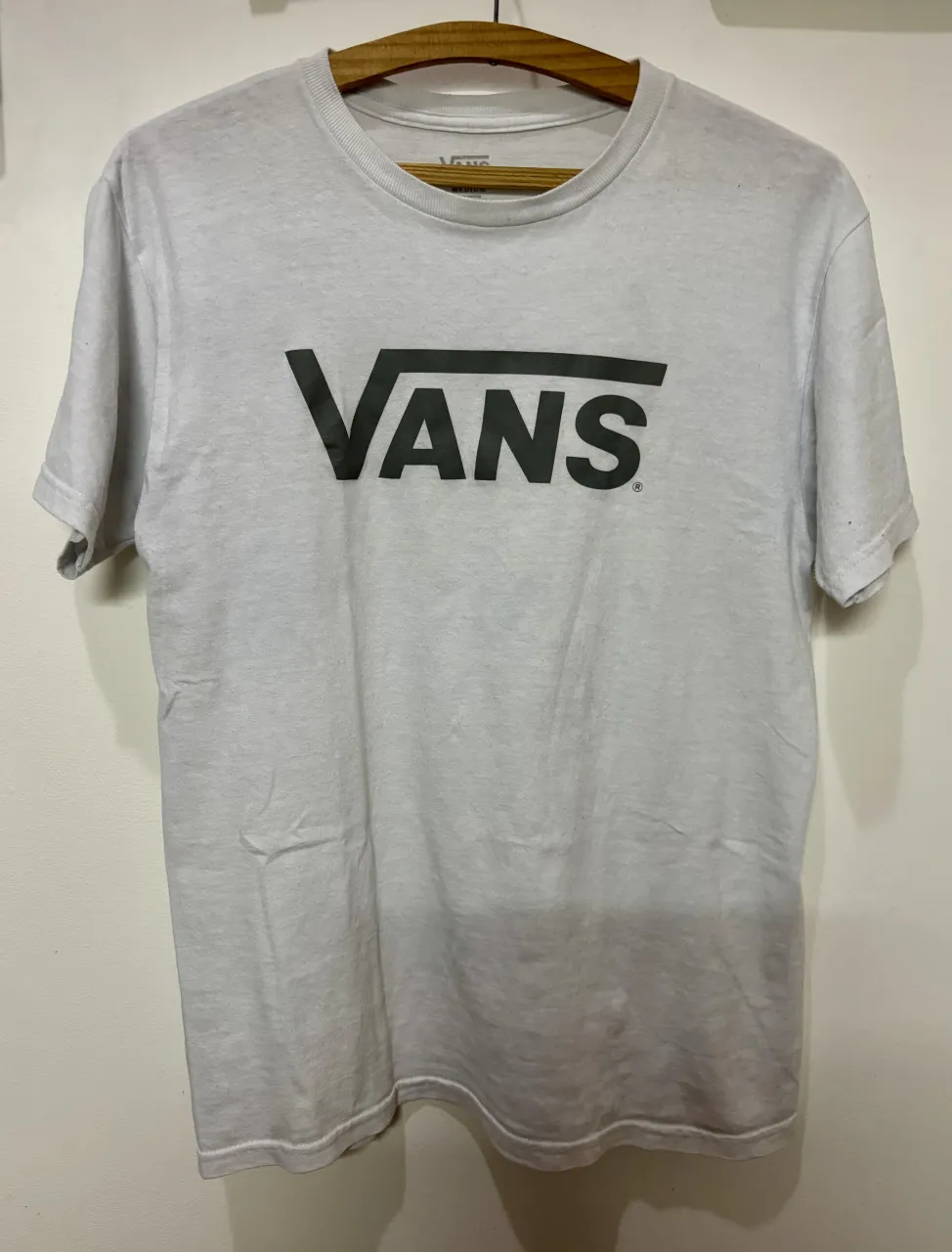 Remera de manga corta gris con logo de Vans estampado en el frente. Ideal para un look casual y urbano.
