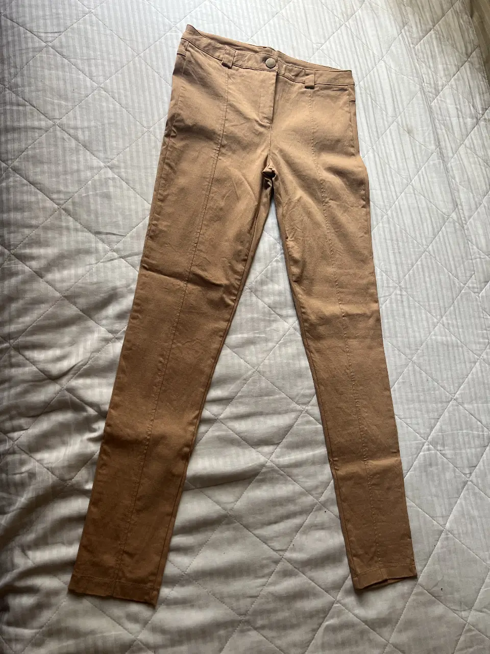 Pantalón sastrero color marrón, con detalles de costura en la parte delantera. Talle L. sería para un talle 38/40. Tiro alto. Elastizado. 