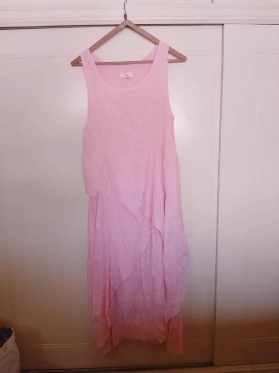 Vestido largo rosa, con capas superpuestas y escote redondo. Ideal para un look fresco y femenino.