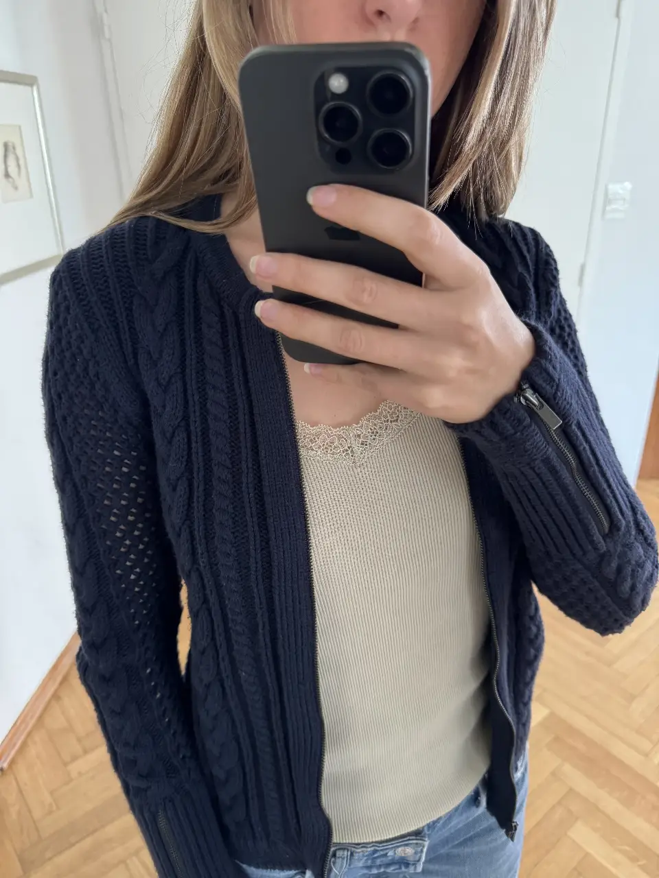 Cardigan de mujer azul marino de punto grueso con cierre y detalles de cremalleras en las mangas. Ideal para un look casual y abrigado.