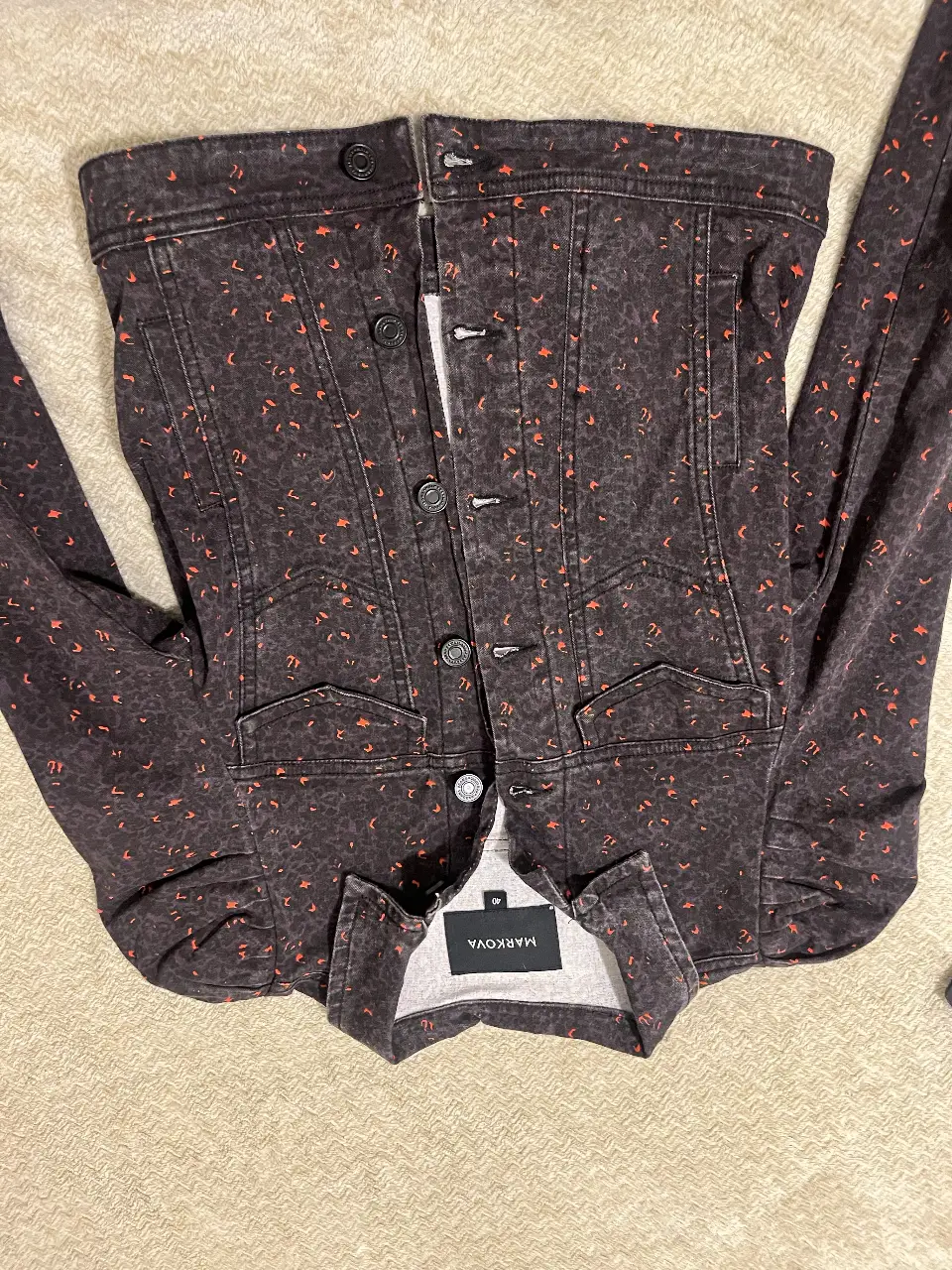 Campera de jean gris oscuro  con estampado de detalles en naranja. Marca Markova, talle 40.