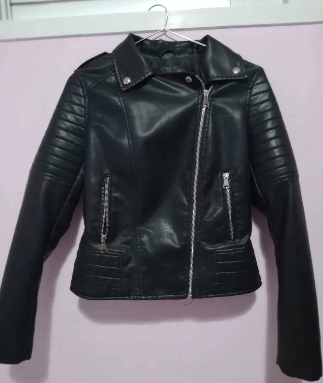Campera biker de cuero sintético para mujer. Corte entallado, con detalles de costuras en los hombros y mangas. Cierre y bolsillos con cierres metálicos. Ideal para un look rockero y moderno.