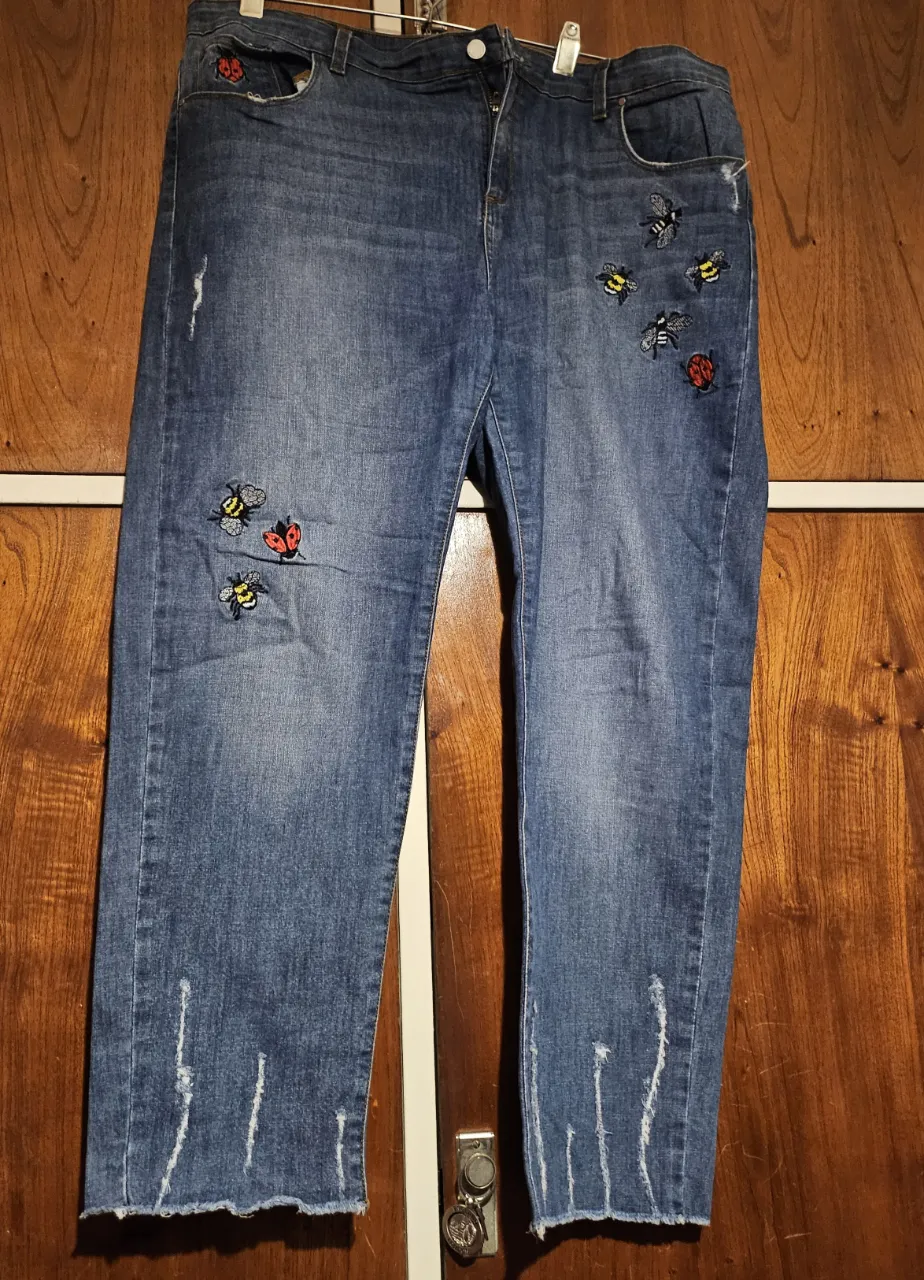 Jeans de mujer, tiro medio, con detalles de roturas y parches de abejas y mariquitas. Un clásico renovado para un look canchero y cómodo.