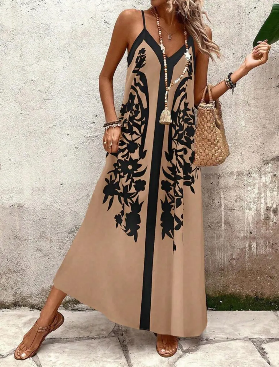 Vestido largo de mujer con estampado floral en color negro sobre fondo crudo. Diseño con tirantes finos y escote en V. Ideal para un look bohemio y fresco.