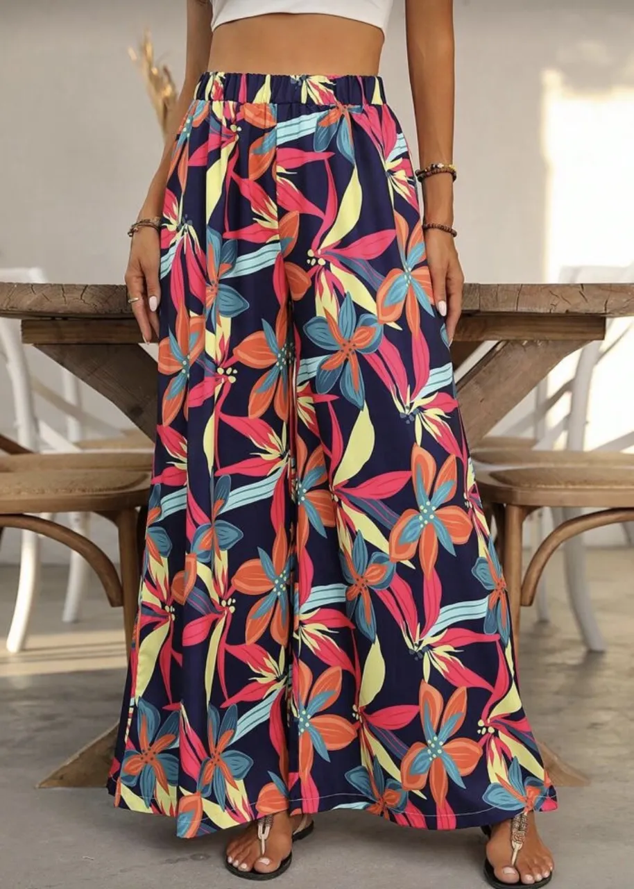 Pantalón ancho con estampado floral multicolor sobre fondo azul marino. Cintura elastizada.